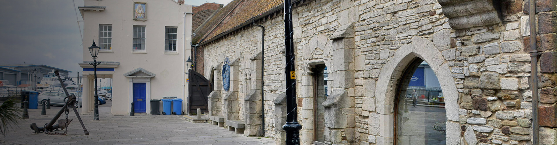 Photo showing an anchor in front of a building