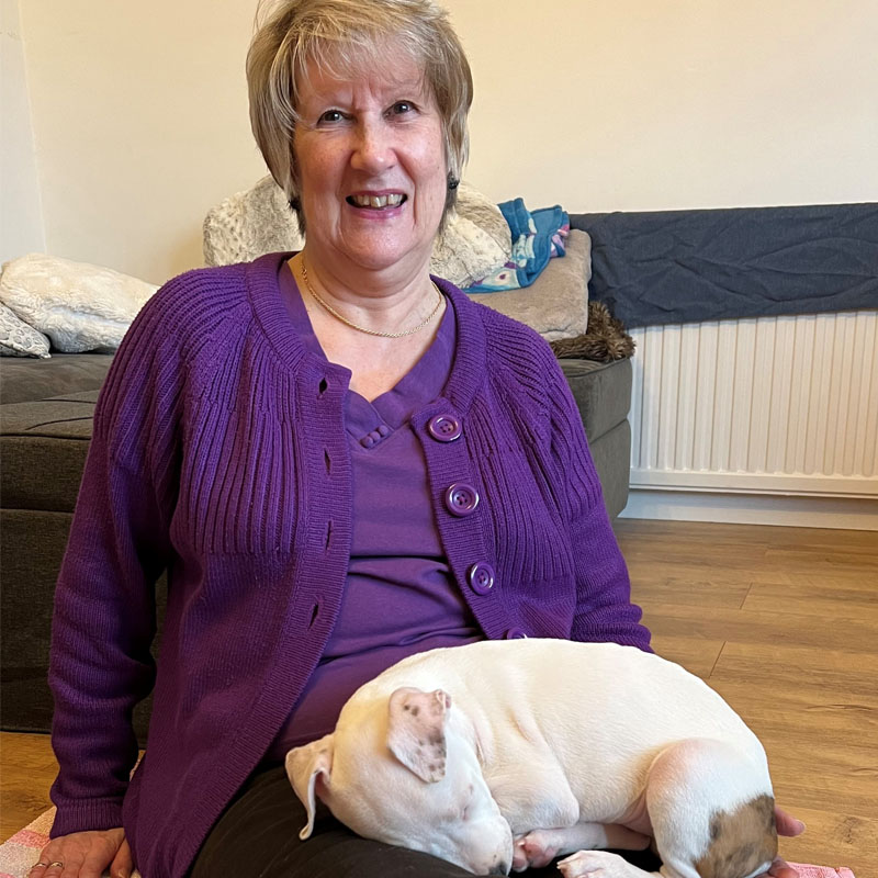 Photo of Lin Fisher holding her dog