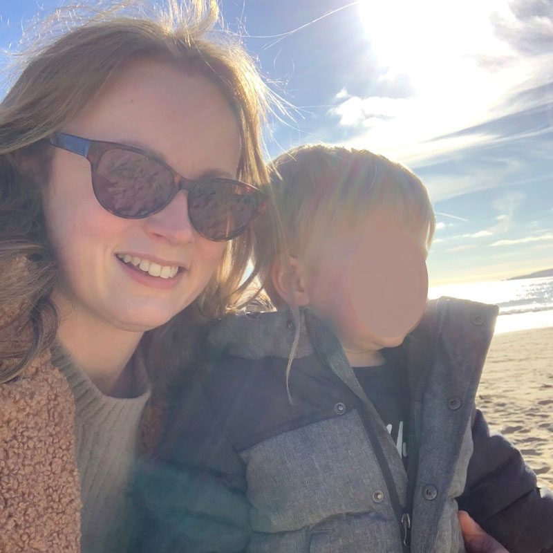 Photo of Vikki Wood on a beach with a toddler